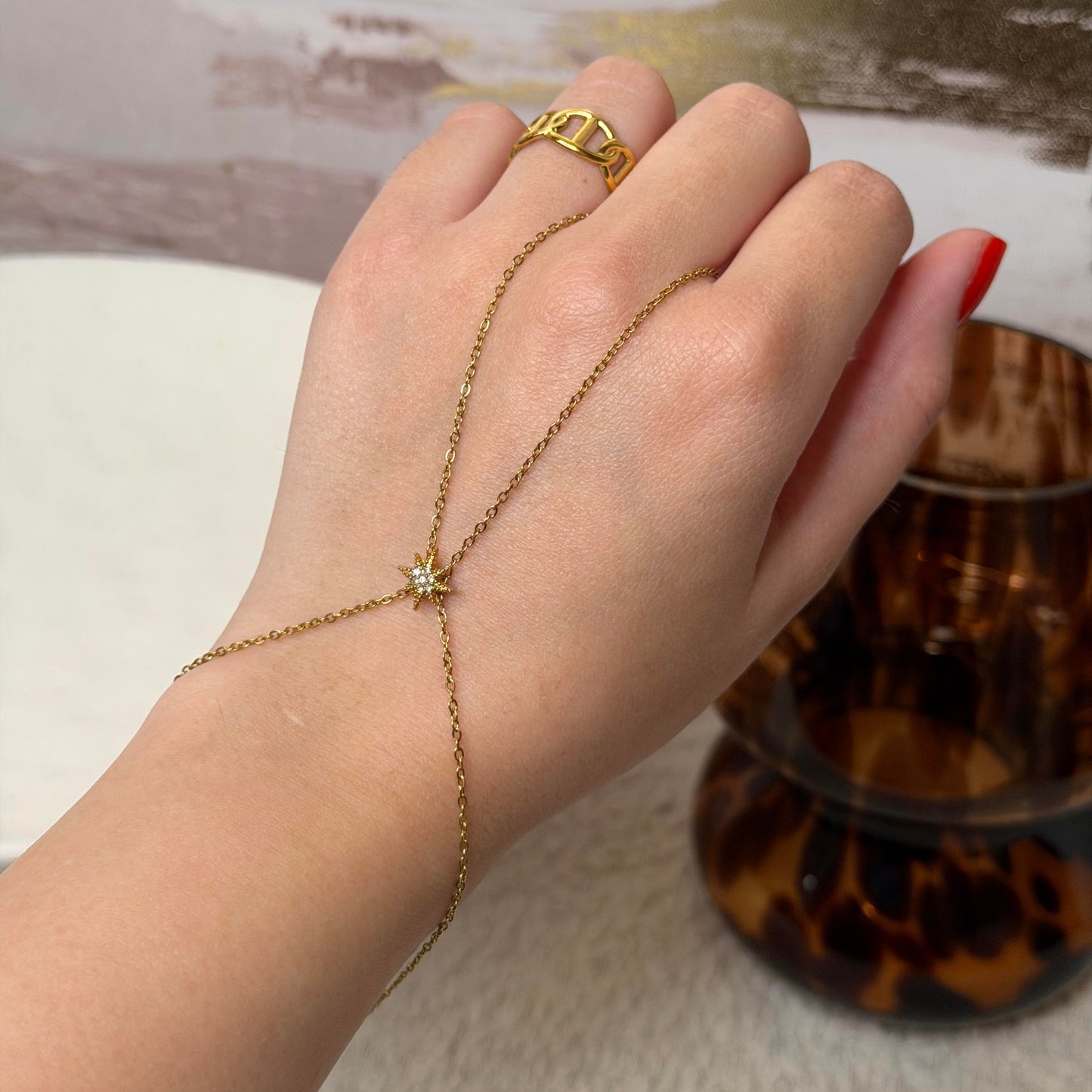 Chaine de main ajustable avec étoile en acier inoxydable et zircons doré Maison Bellano